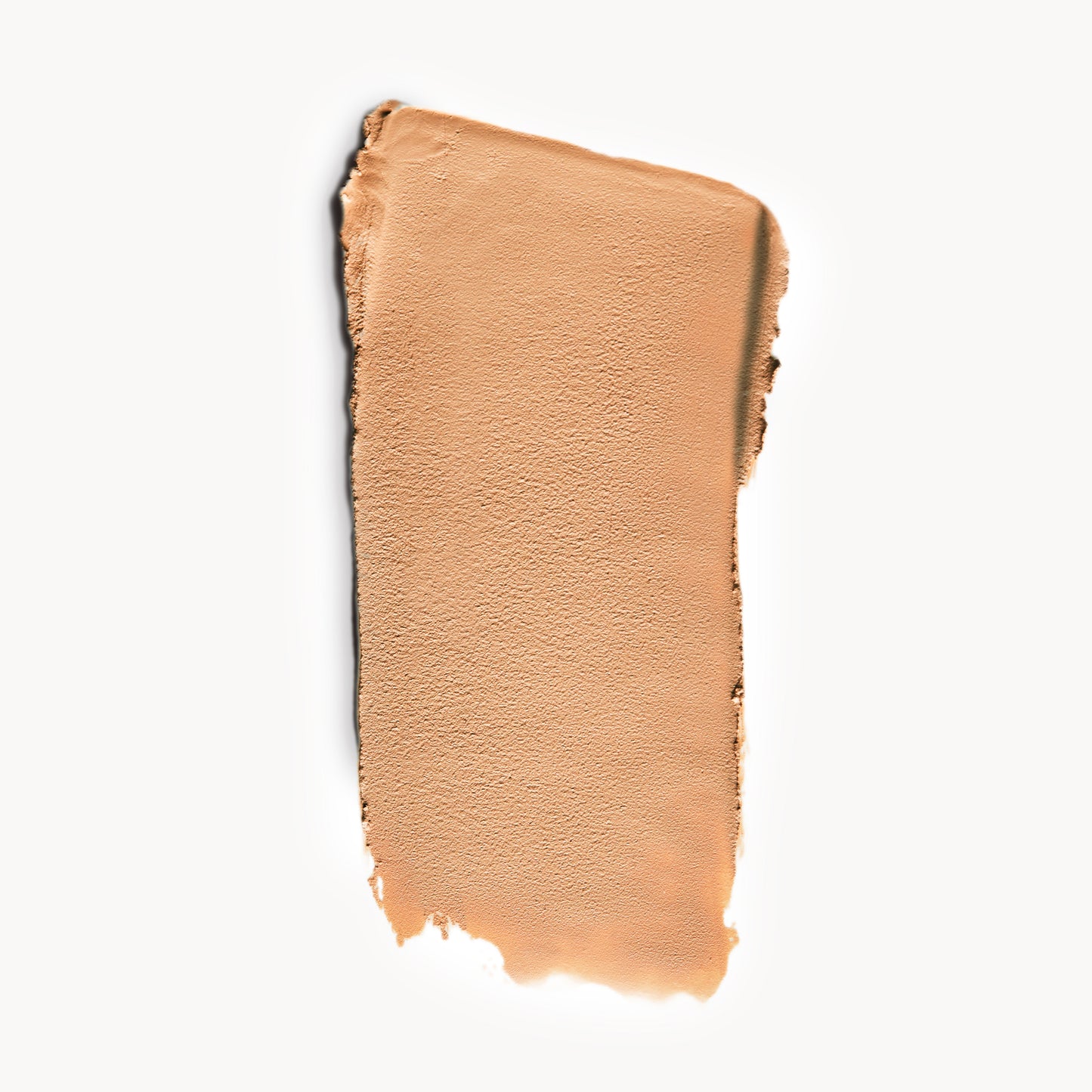 A wipe of medium, neutral-toned cream foundation on a white background