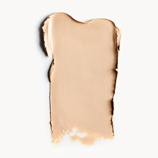 a wipe of fair, neutral-toned cream foundation on a white background