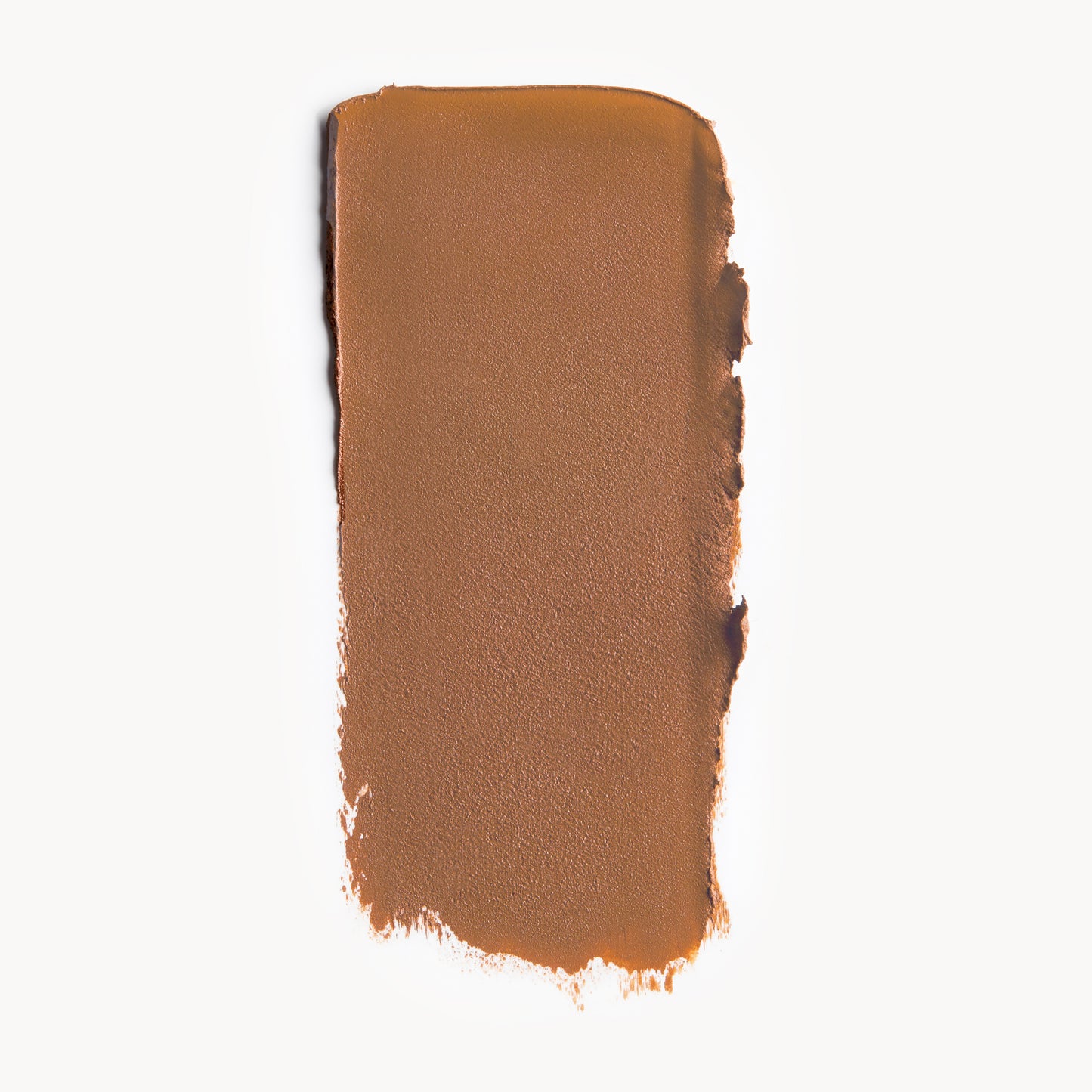 A wipe of tan cool-toned cream foundation on a white background