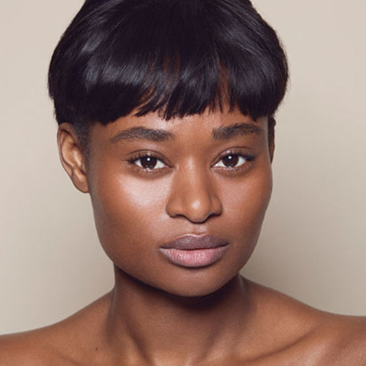 photo of a person’s face with deep, neutral-toned skin