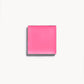 A square of vibrant pink cream blush on a white background