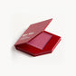 A red KW palette with the lid open to show the cream blush