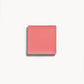 A square of rosy pink cream blush on a white background