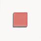 A square of soft coral cream blush on a white background