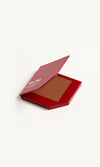 Red KW palette with lid open to show cream foundation 