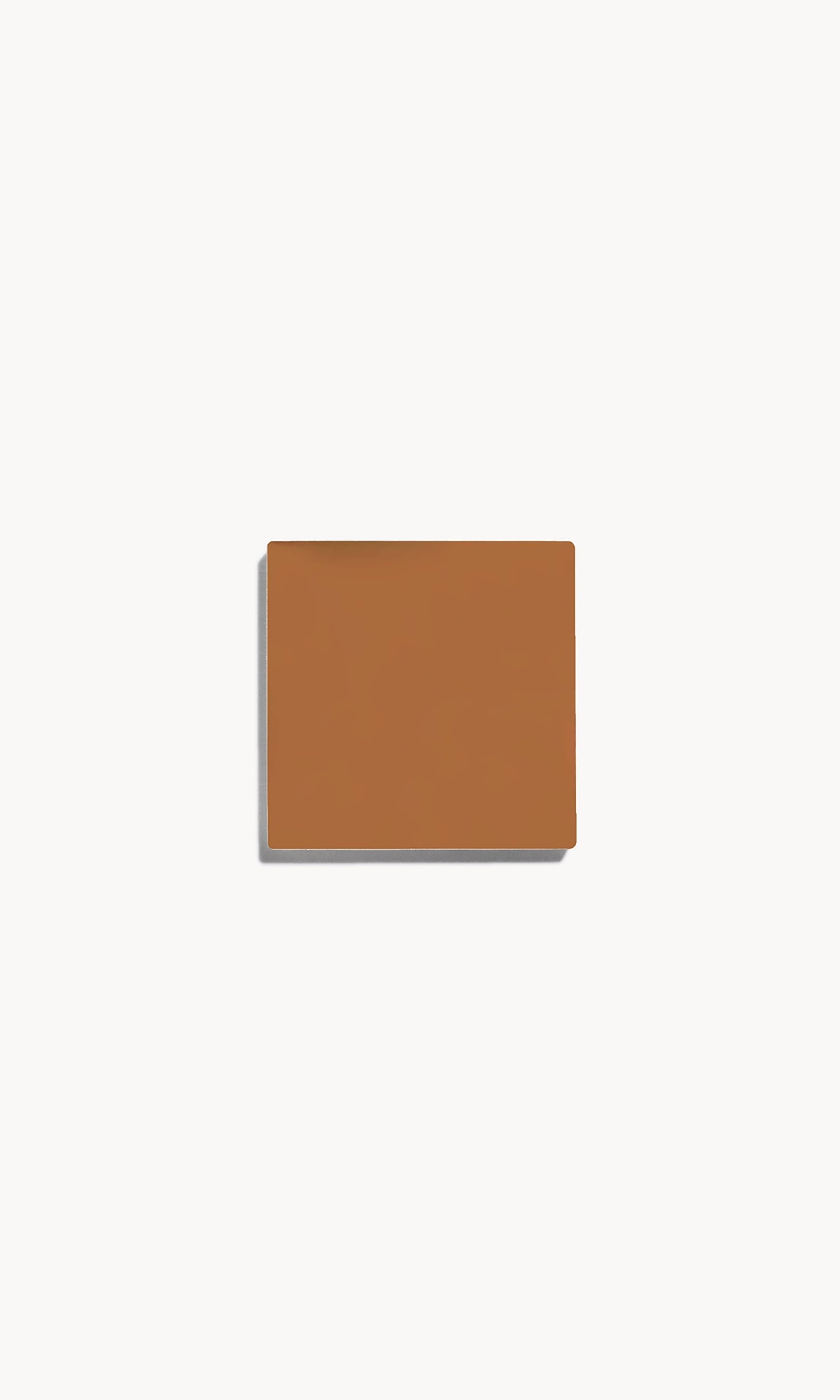 square of warm tan cream foundation on a white background