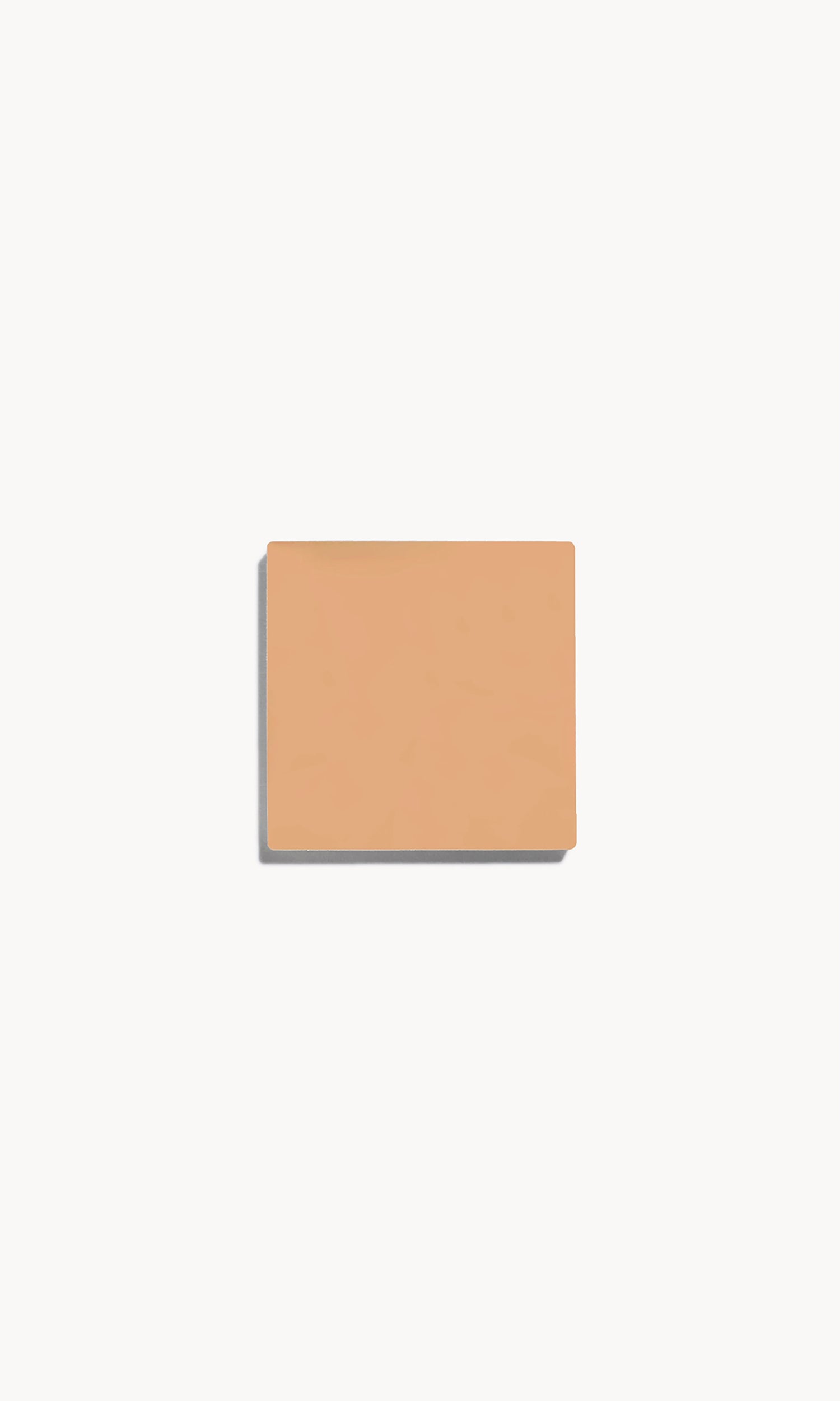 square of medium neutral-toned cream foundation on a white background