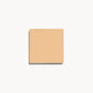 Square of light warm cream foundation on a white background