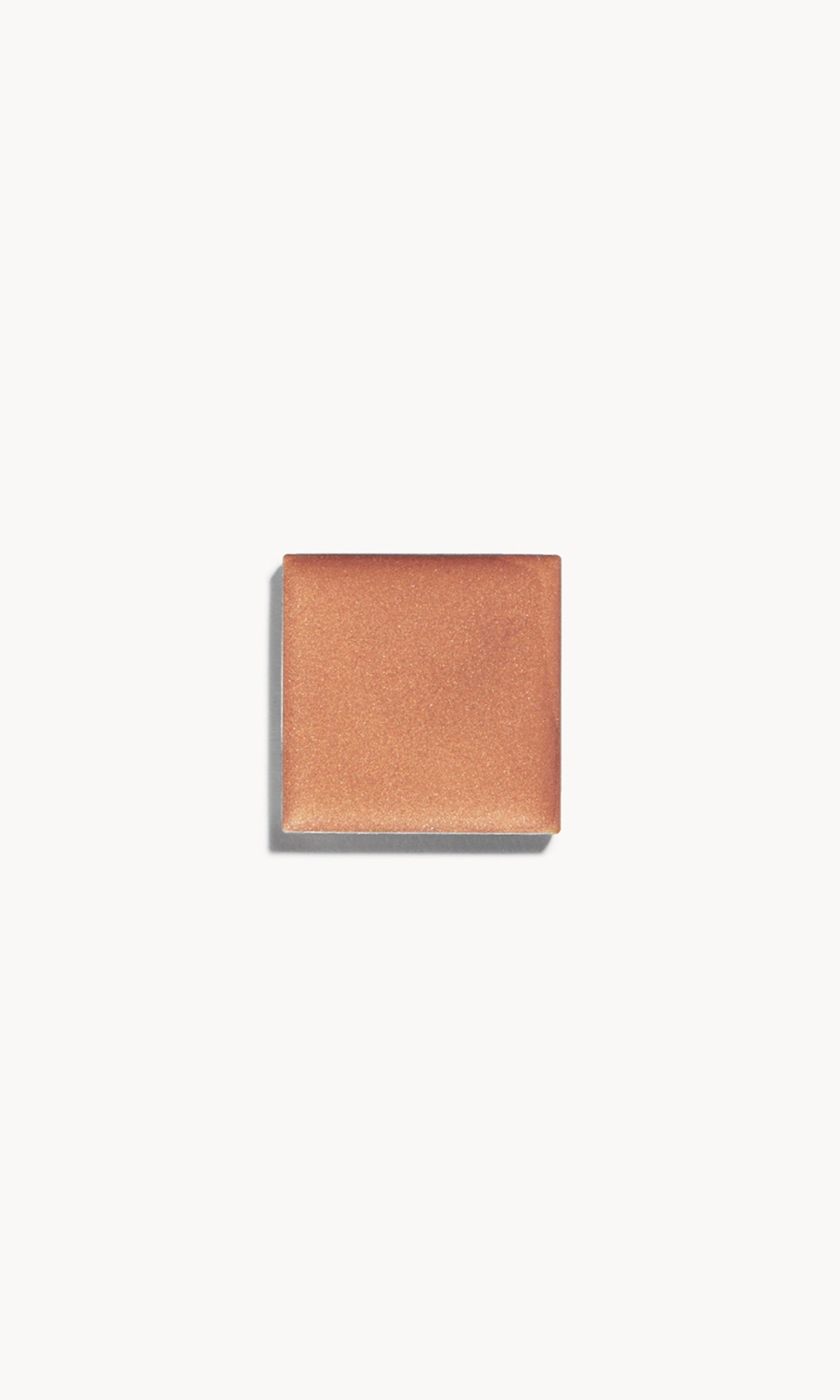 A square of warm copper-tone cream bronzer on a white background