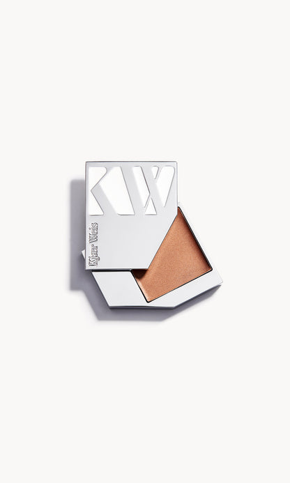 A solid metal KW palette with the lid slid open to show the cream bronzer