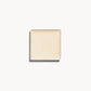 A square of warm golden champagne cream highlighter on a white background