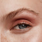 Close up of person’s eye with a fair skin tone wearing cream eye shadow