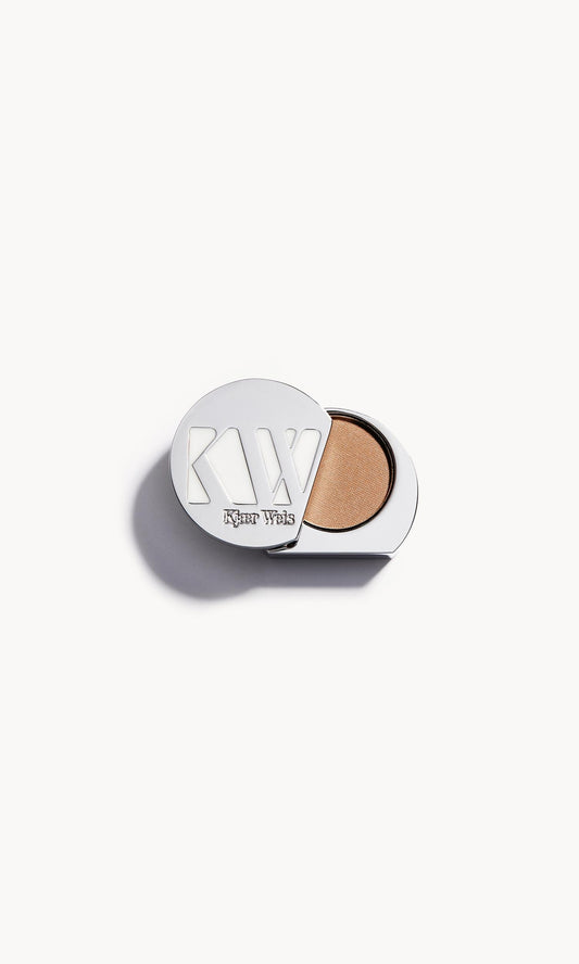 solid metal kw palette with lid open to show warm beige eye shadow inside