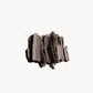 Crumbled up greyish brown eye shadow on a white background