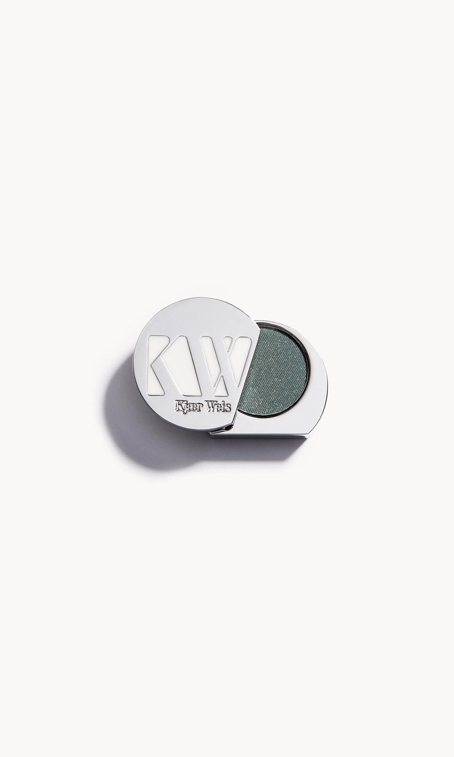 Solid metal KW palette with lid open to show green eye shadow with gold flecks inside