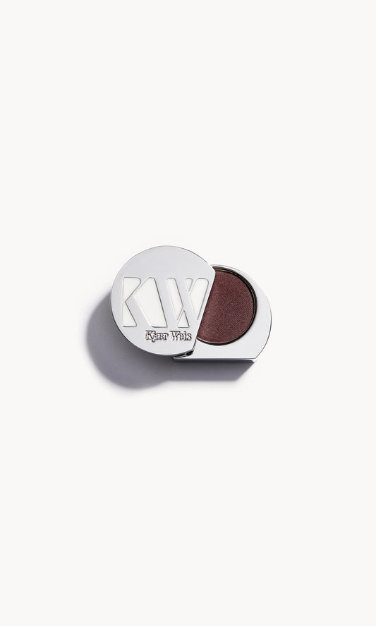 solid metal kw palette with lid open to show metallic reddish-brown copper eye shadow inside