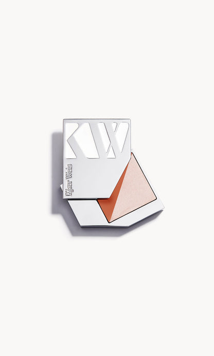 Silver metal KW palette open to show a rectangle palette split diagonally in half, with a moon sheer cream highlighter on one side and a sunlit bronze cream blush on the other