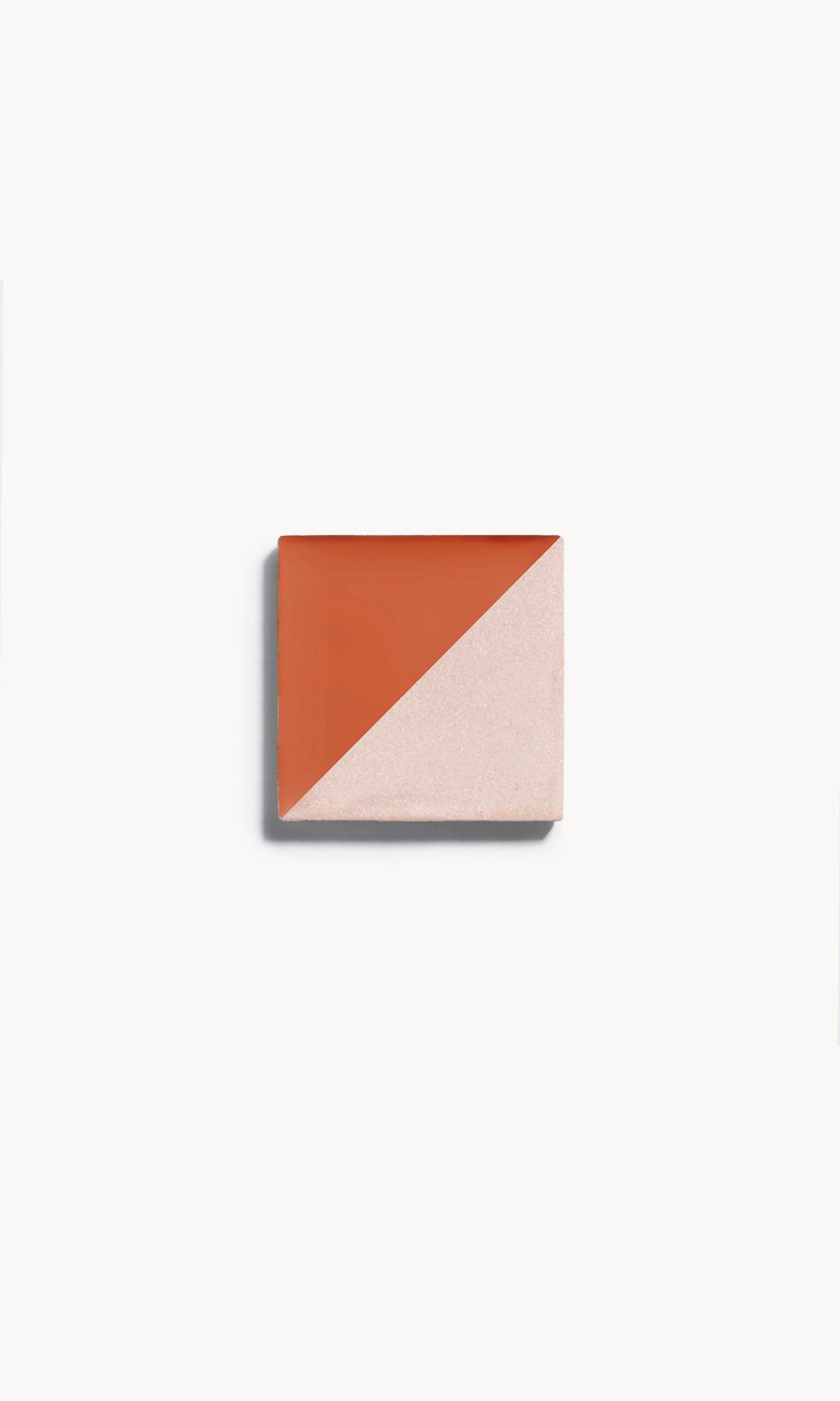 a square of cream blush and cream highlighter, split diagonally with a shade on each side