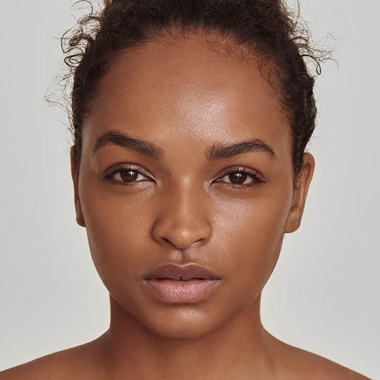 photo of a person’s face with deep, warm-toned skin
