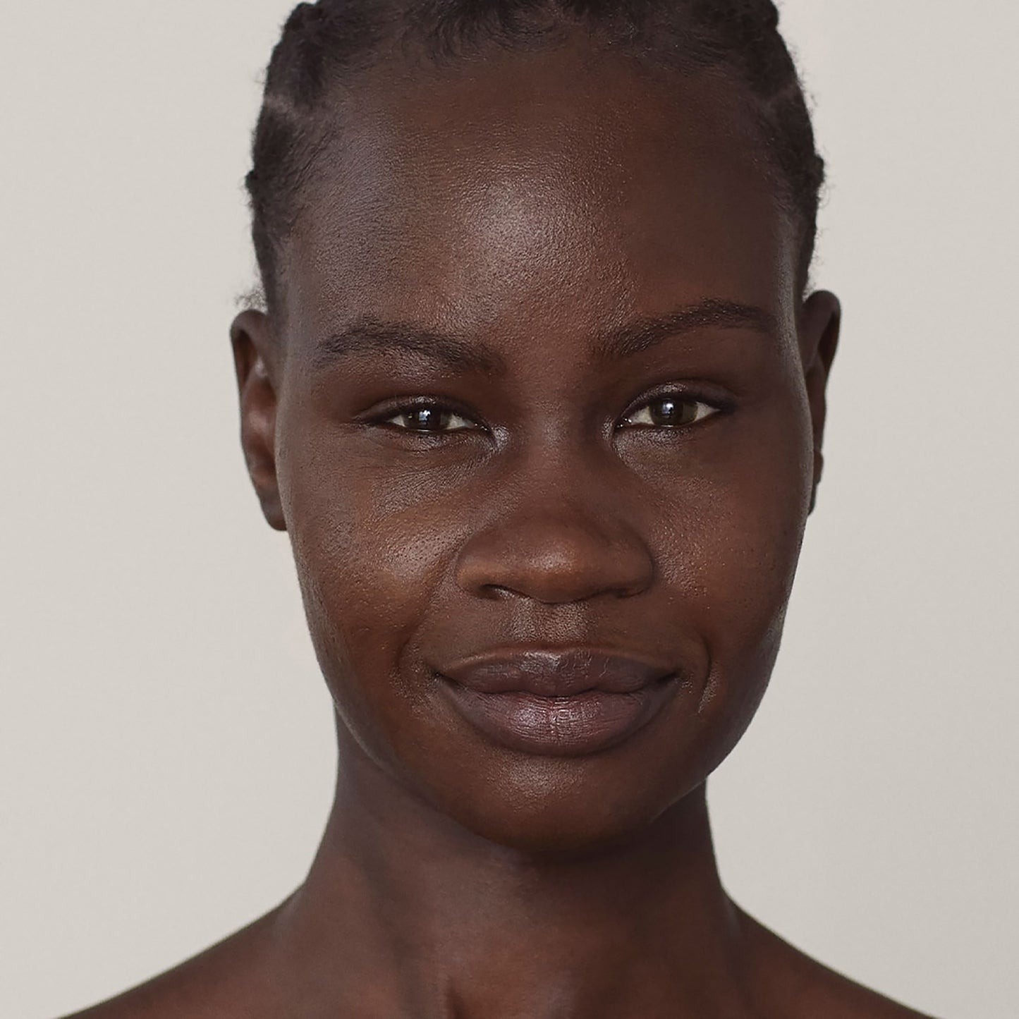 A photo of a person’s face, with deep warm skin tone