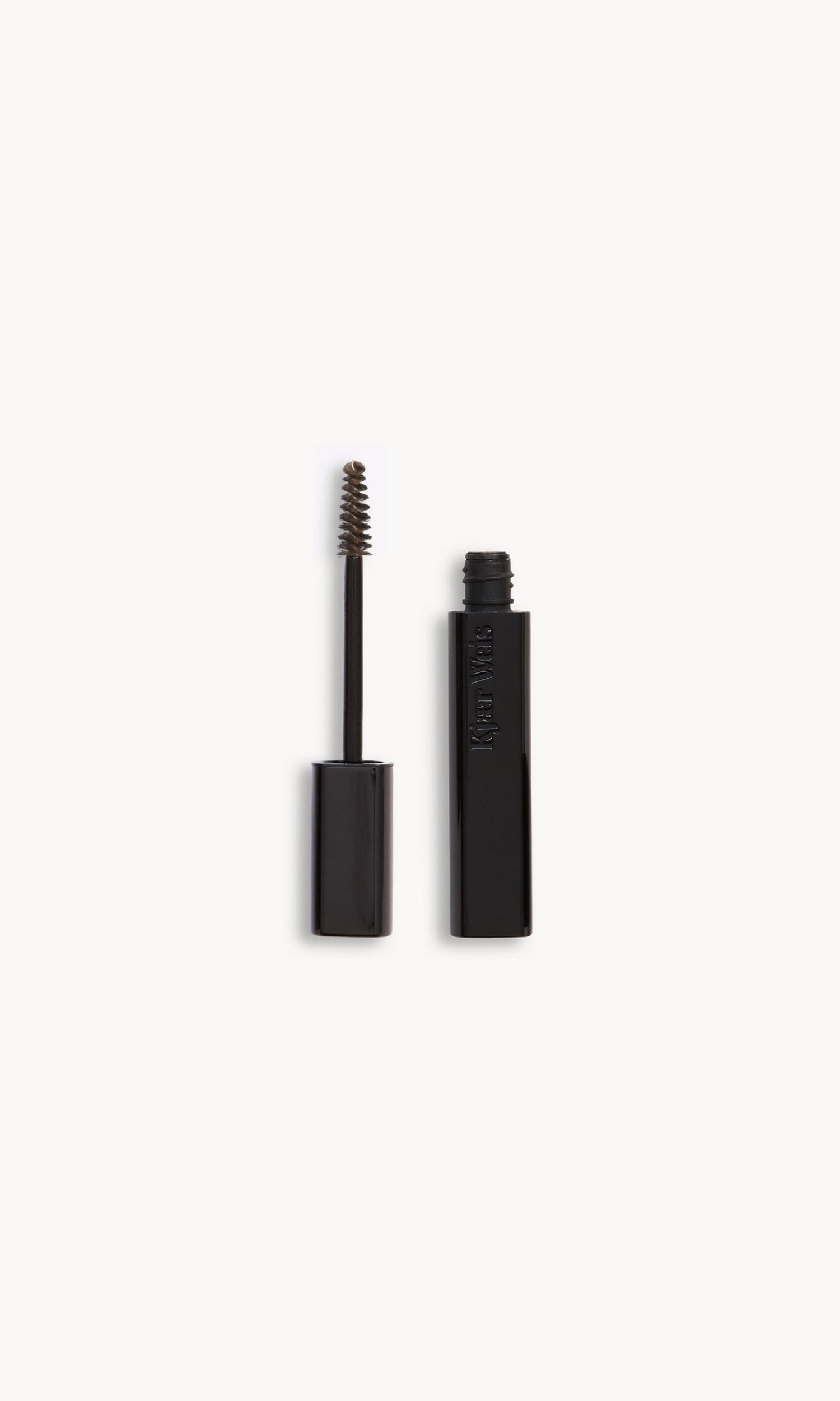 Kjaer Weis brow gel wand and bottle side by side, with a medium shade of brown product on the wand
