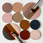 Eye shadow palette refills arranged with the large quadrant eye shadow next to the four smaller refills of each shade. 