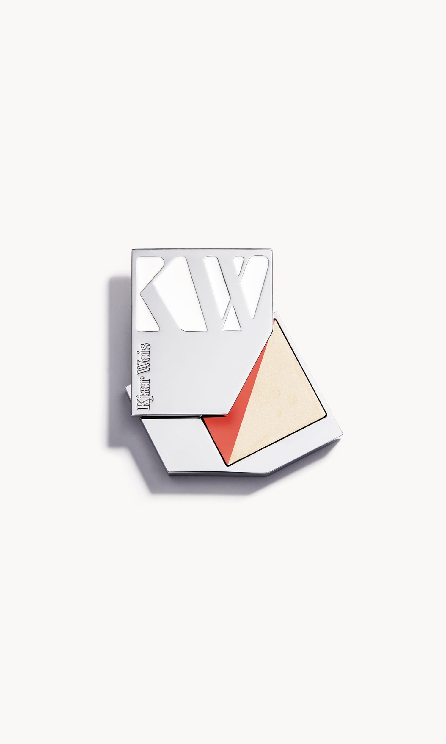 silver metal kw palette open to show a rectangle palette split diagonally in half, with a warm coral blush on one side and a golden cream highlighter on the other