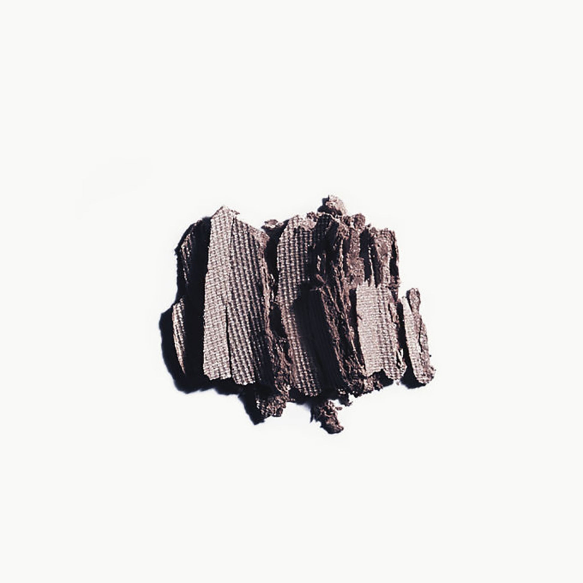 Crumbled up taupe eye shadow on a white background