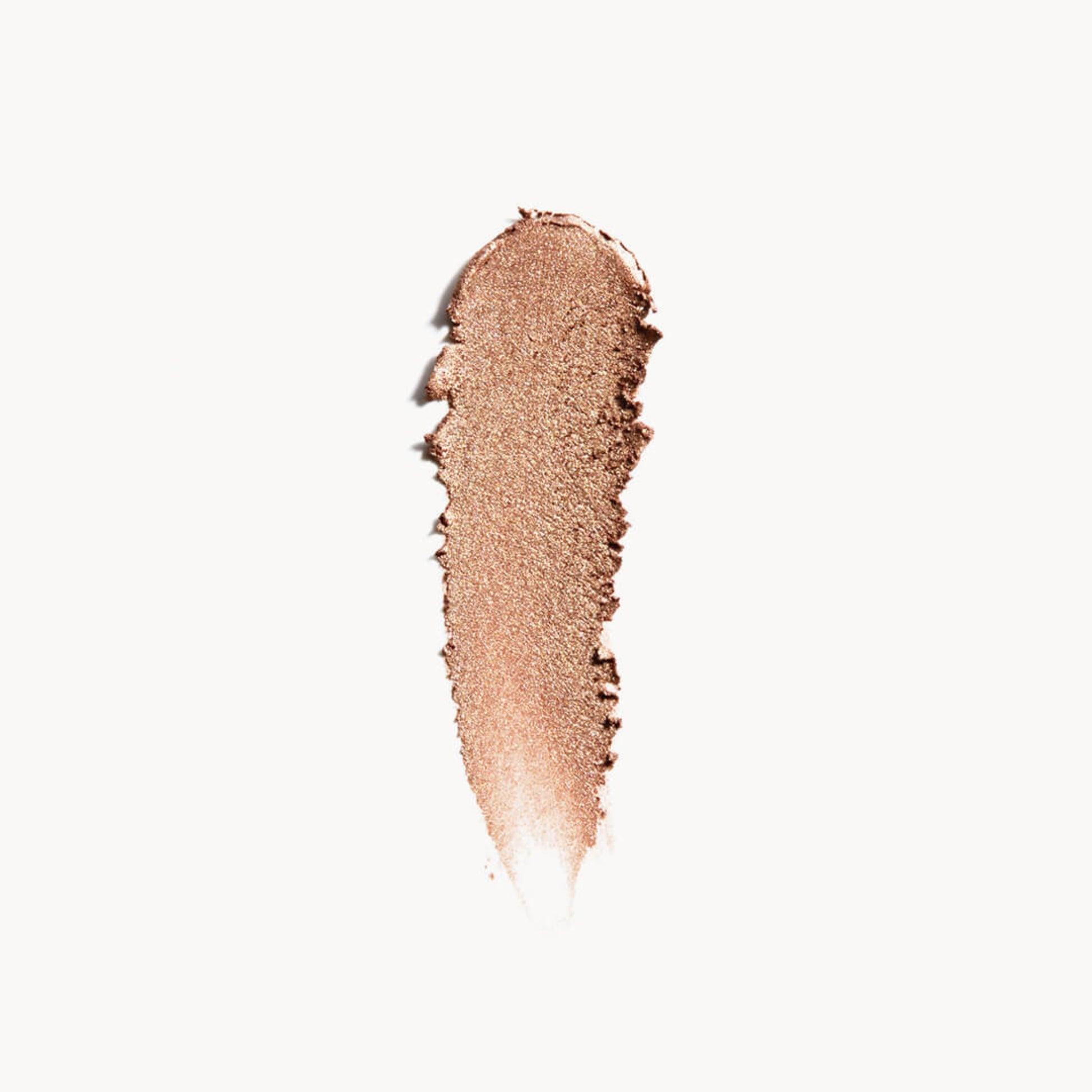a wipe of iridescent peach gold eye shadow on a white background