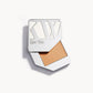 Solid metal palette with the lid slid open to show the cream foundation